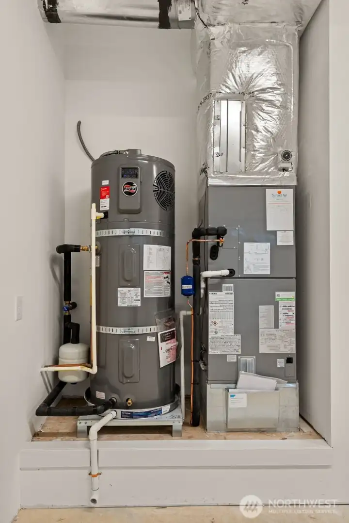 High efficiency Carrier electric forced-air furnace and Electric hybrid water heater.