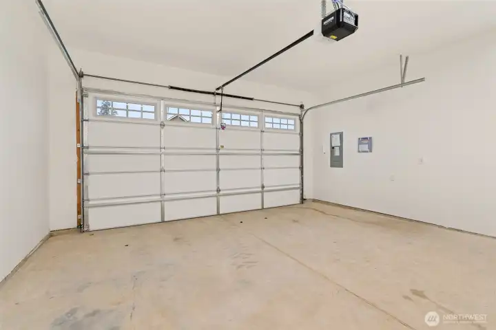 Double car garage is drywalled and includes garage door opener.