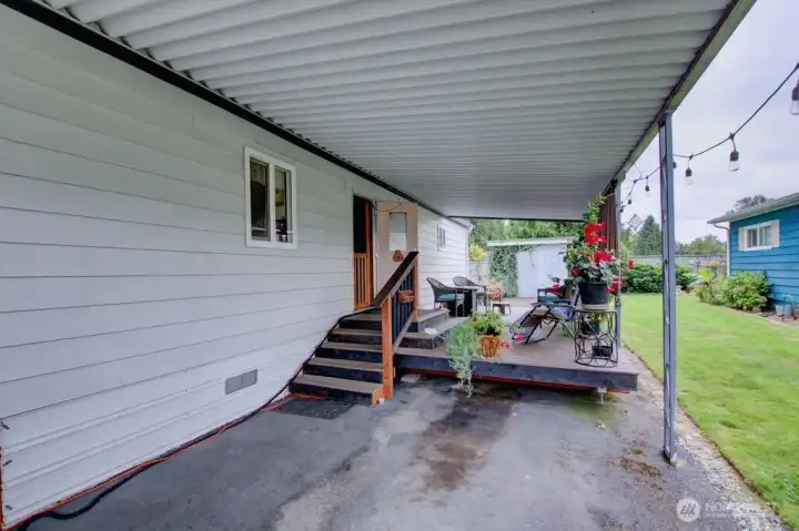 Covered west side entrance with stairs. Large deck for entertaining.