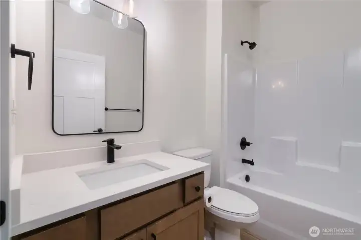 Main level guest bathroom - Pics are of a different 3049 plan. Features and colors may differ.