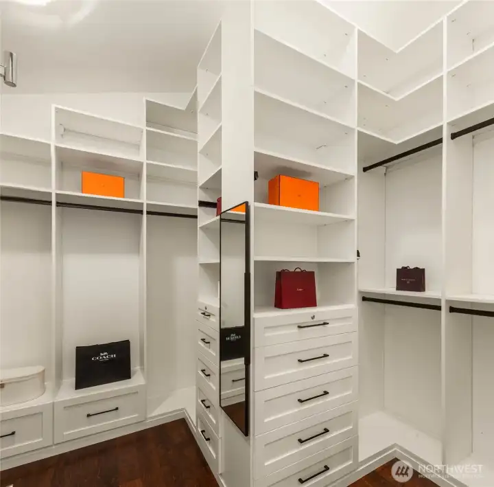 Walk-in closet with custom design California closet system.