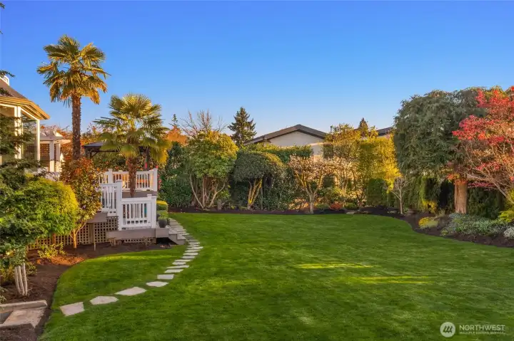 Professionally landscaped with landscape lighting and large flat lawn, big enough for sports court or pool.