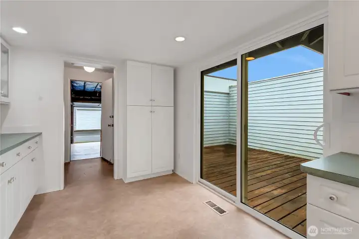 Pantry cupboard and entry to the laundry room and also garage. Just enough room for a small bistro table by the patio door.