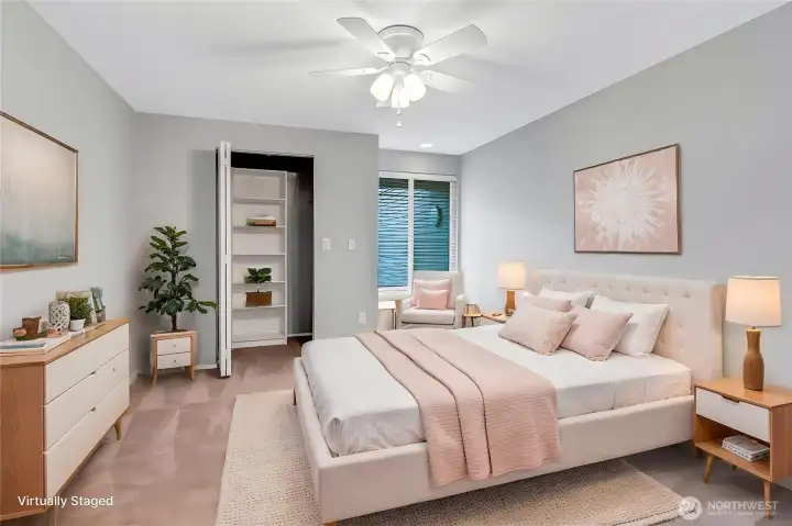 Primary bedroom with spacious closet including built in shelving. (virtually staged)
