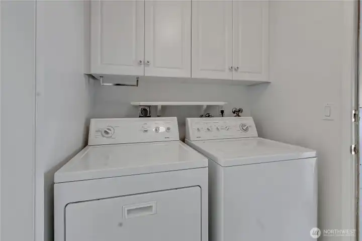 Laundry room located conveniently between the kitchen and garage.