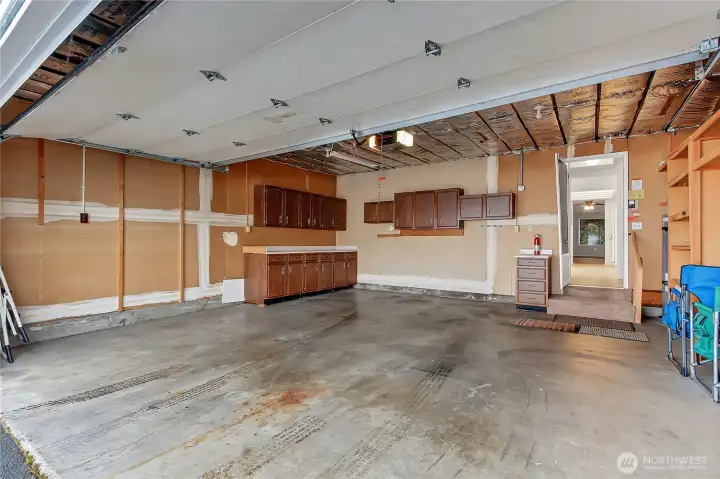 Massive 2-car garage with large work bench/counter area and lots of built in storage shelving.