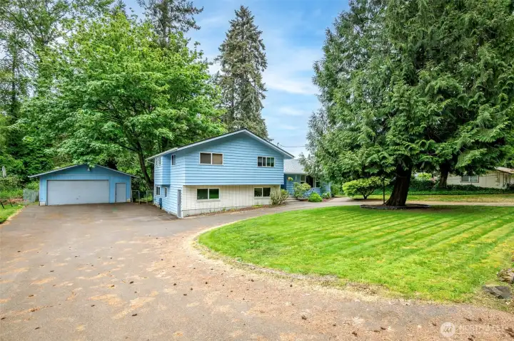 Front of home showing circular driveway and shop.