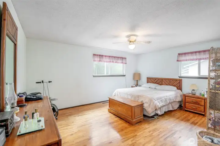 Primary bedroom, so much light and hardwood floors.