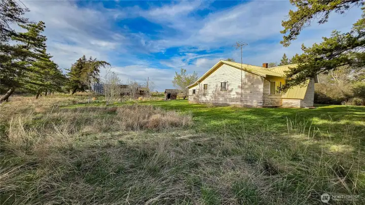 Looking NE from the SW corner of the home: The yard currently offers great space, with plenty of potential to be extended even further if you need more room to play or relax.
