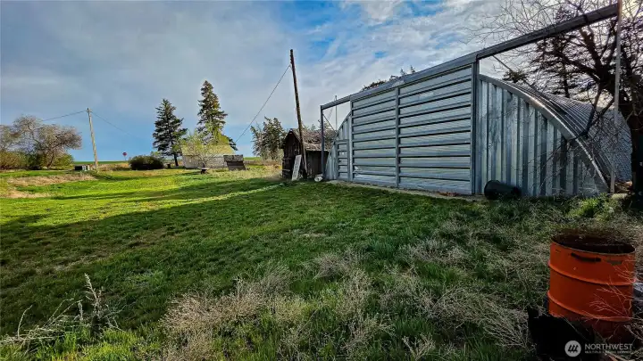 Looking South from the North area: A large driveway provides seamless access across the entire property. The massive 40x60 Quonset hut-style shop is a major bonus, offering incredible space for all your projects, equipment, and parking needs.
