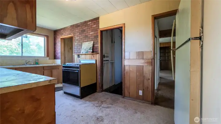 The kitchen has a lot of room to move and a large amount of storage with room to expand storage. Looking SE.
