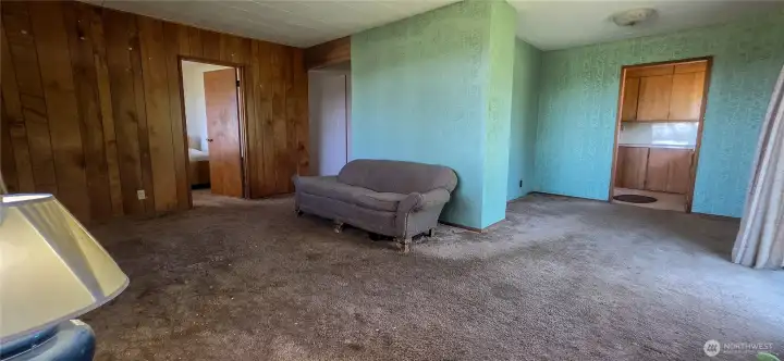 The expansive living room provides plenty of space to relax and features a versatile bump-out addition that perfectly serves as a small home office or reading nook. Looking NW from SE corner of home.