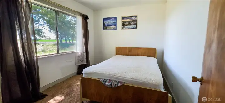 Bedroom 1 is located at the Southwest corner of the home. This bright and inviting space is flooded with natural light, continuing the home's welcoming feel.