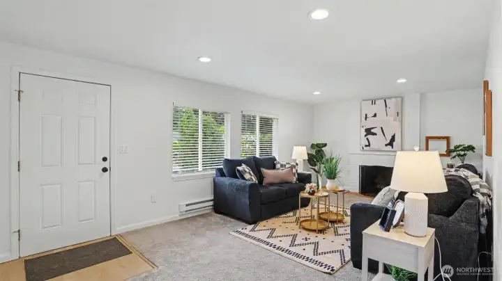 Walk in to the light and bright living room with wood-burning fireplace.