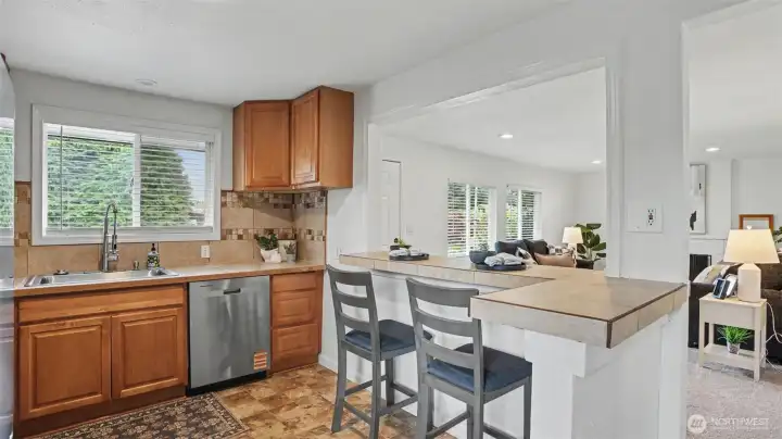 This full kitchen offers an eat-in option with a functional bar-top.