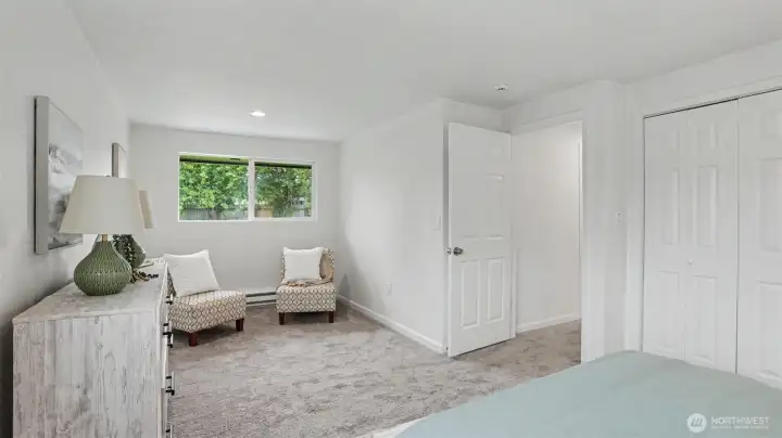 Serene sitting area in the primary bedroom, perfect for relaxing with a book.