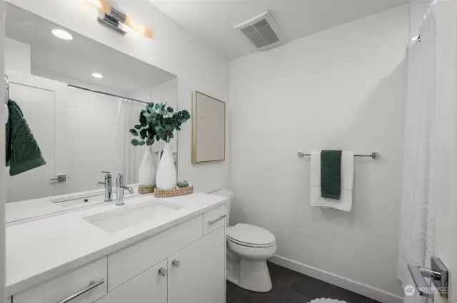 A bright and airy full bathroom, combining simplicity and modern style, is designed to refresh and relax.