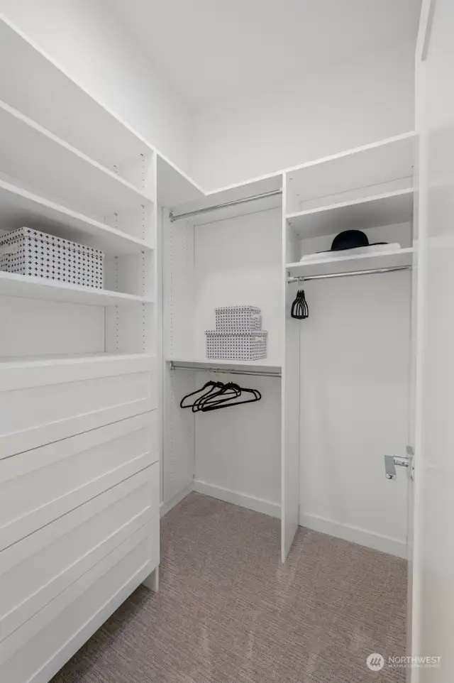 Spacious walk-in closet with organized shelving and storage, offering ample space for all your essentials.