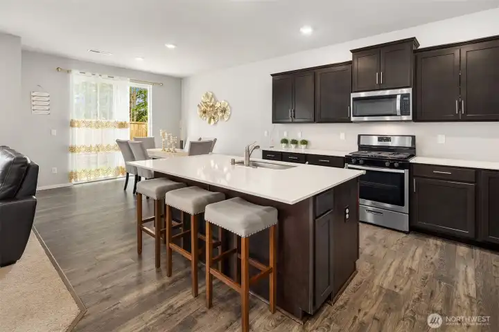 Quality kitchen cabinets with plenty of storage space. Nice stainless steel appliances, gas cooktop, microwave oven, French Door Refrigerator, and dishwasher.  Lovely kitchen island for your family!