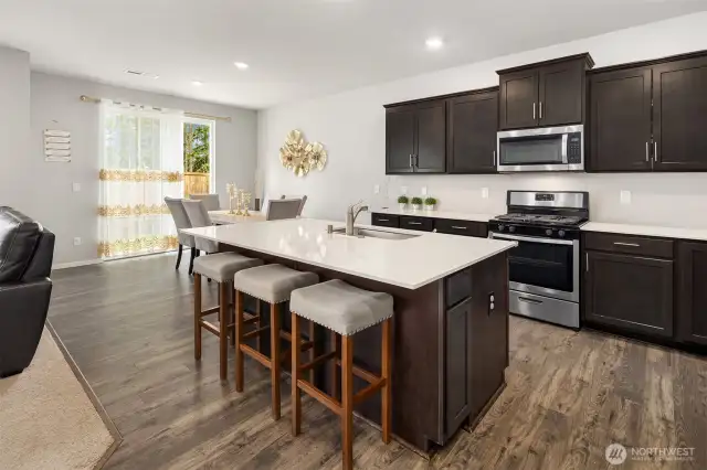 Quality kitchen cabinets with plenty of storage space. Nice stainless steel appliances, gas cooktop, microwave oven, French Door Refrigerator, and dishwasher.  Lovely kitchen island for your family!