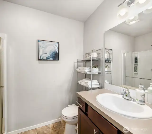 3/4 Bathroom off the main level hallway. Has a shower too! Across the hall from the main level bedroom / den depending on how you choose to use it.