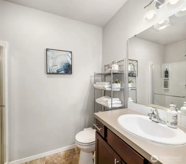 3/4 Bathroom off the main level hallway. Has a shower too! Across the hall from the main level bedroom / den depending on how you choose to use it.