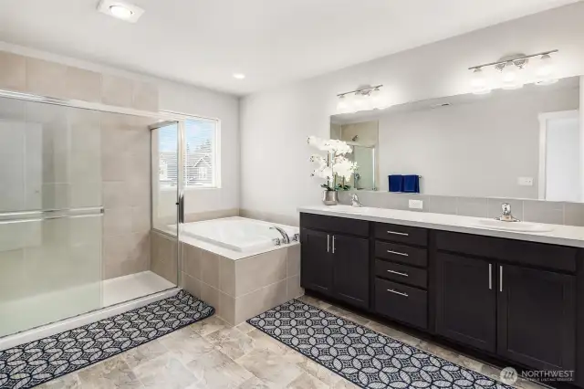 A larger primary bathroom offers a luxurious design with soaking tub, big walk in shower, double sinks, separate  toilet room, and the larger walk-in closet to the right side.