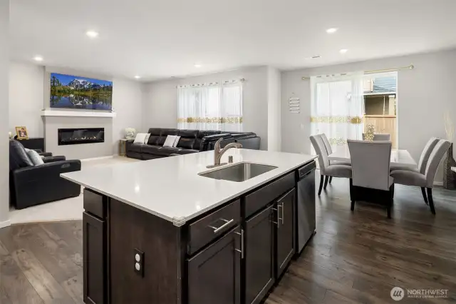 Open Design in the main living area! Larger kitchen island with sink and breakfast bar. Nice wood flooring.  Semi formal dining area, and a big living room with fireplace!