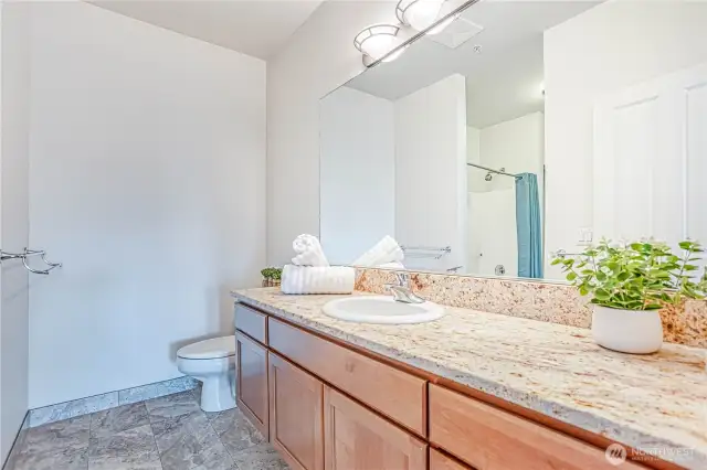 guest bath off of hallway and directly across from 2nd bedroom.