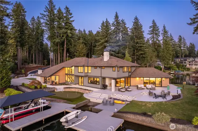 Northwest side of the property. Two docks adjoined by a bridge. Extensive patios, 4 hole putting green.