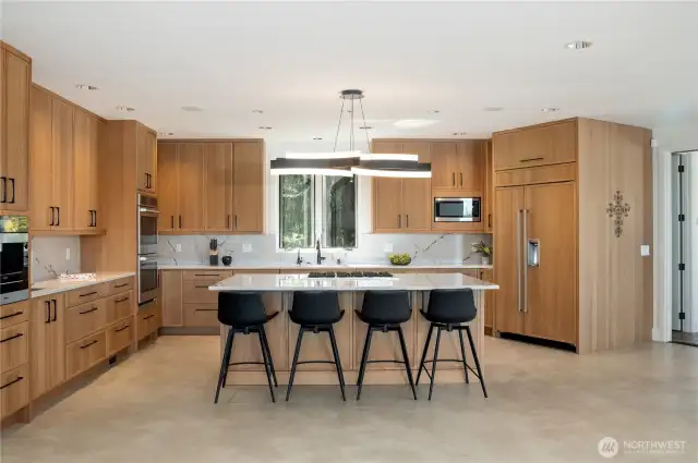 The kitchen is grand to match the views. Large seating area island, Sub Zero, Miele built-in coffee maker, quartz countertops, Belmont cabinets double ovens and two sinks!