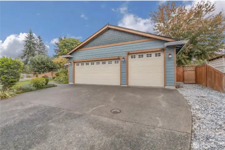 3 Car garage with large parking pad.