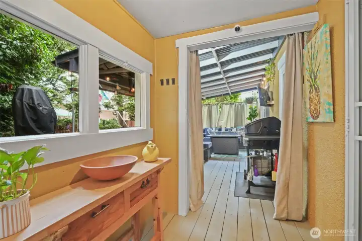 Covered area leading to covered deck and side yard