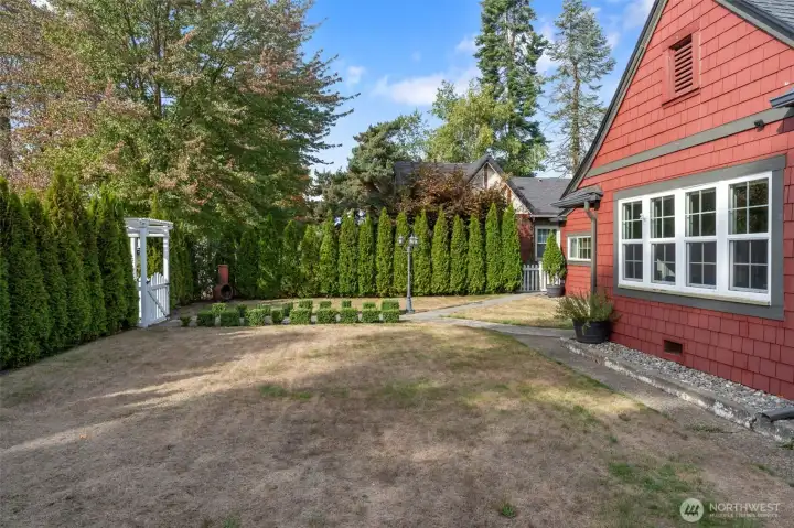 Fully fenced yard with sprinkler system for easy maintenance.