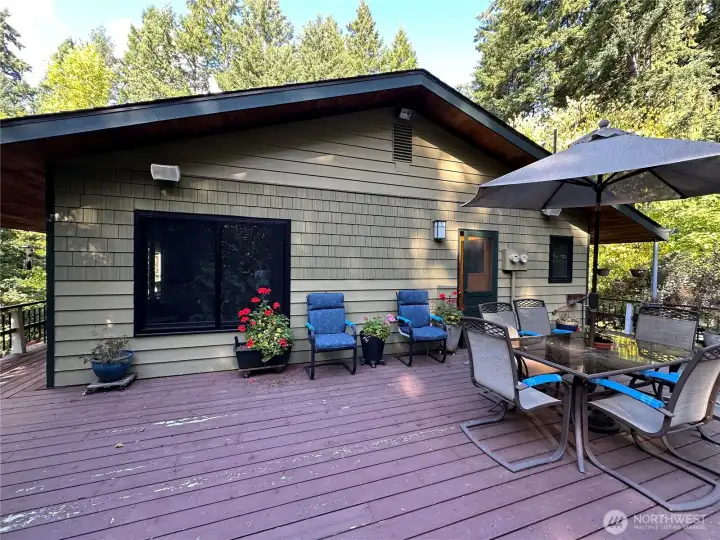 Large deck with outside speaker, an amazing space for entertaining. Door leads into a large mudroom, with sink, pantry and laundry area. A powder room bathroom is also inside this door.