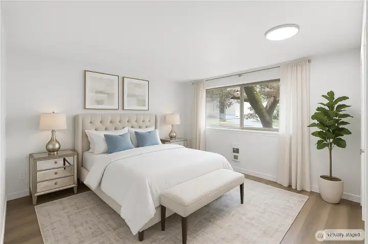 1 of 2 light filled bedrooms with modern luxury plank vinyl.