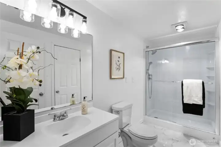Contemporary remodeled bath with marble pattern ceramic tile
