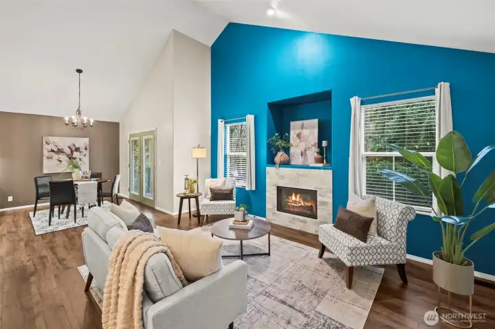 Family room has soaring ceilings, bright windows and a gas fireplace perfect for cool evenings