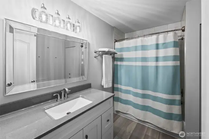 Stylish and roomy updated hall bath.