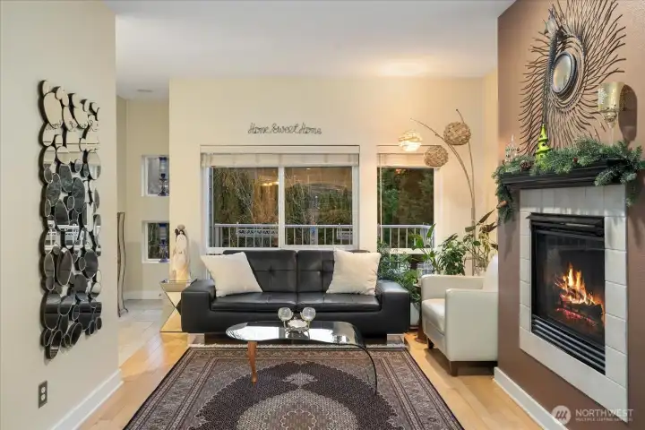 Open living with high ceiling, gas fireplace, dining, and breakfast bar. Built-in ceiling speakers throughout.