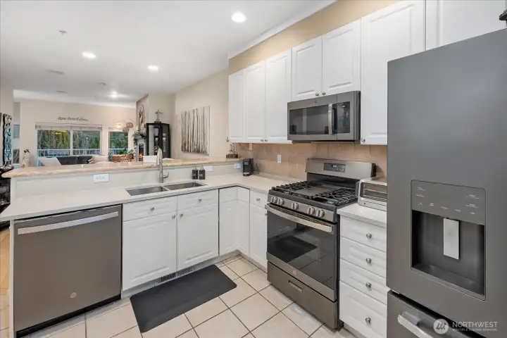 Plenty of cabinets, tiled backsplash, and premium stainless steel appliances.