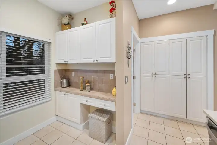 Spacious pantry storage and convenient in-kitchen desk.