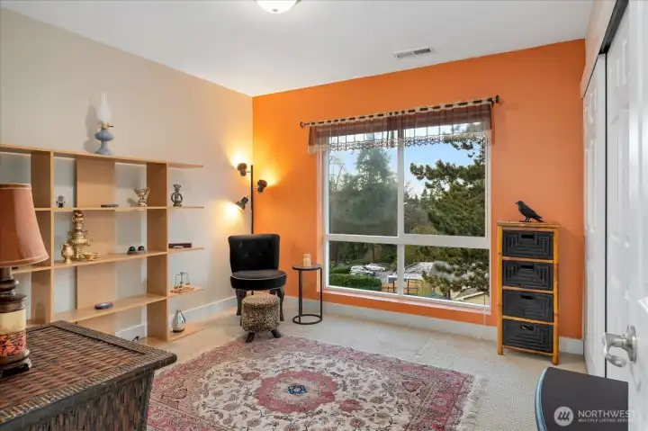 2nd bedroom with a large picture window and treetops views.