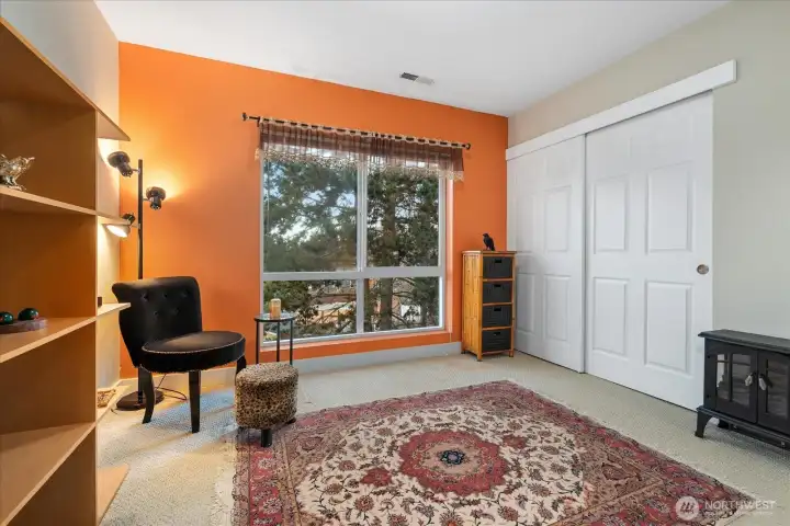 2nd bedroom with a large picture window and treetops views.