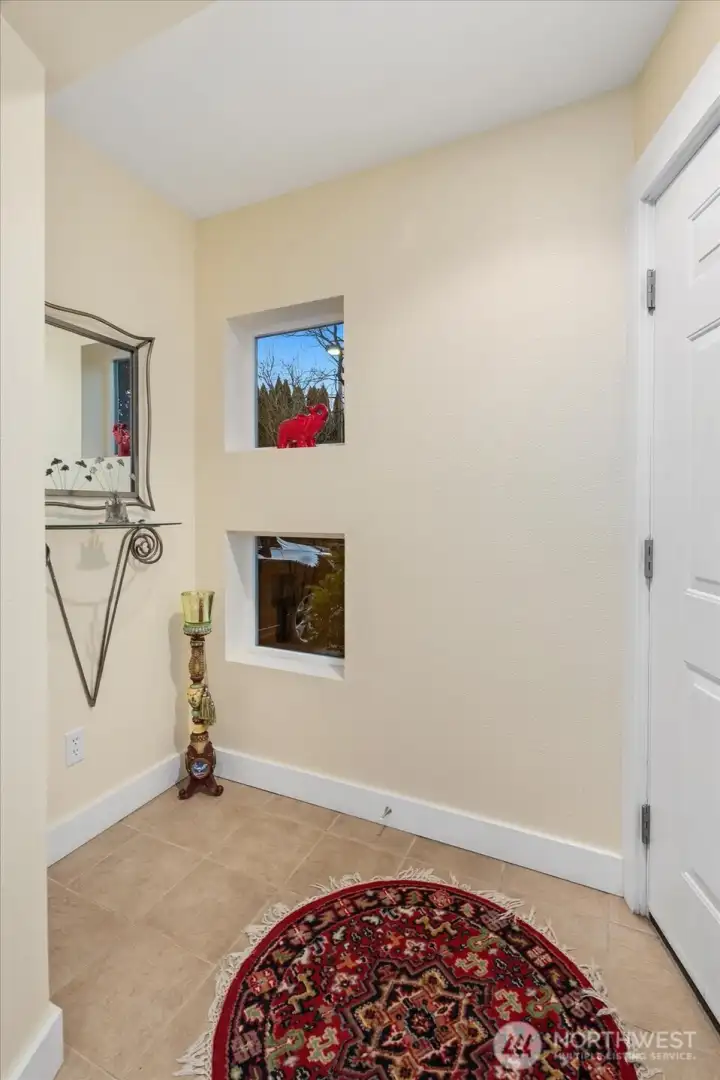Welcoming entry with coat closet and natural light.