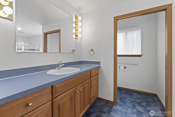 Primary bathroom offers ample counter space and storage space.