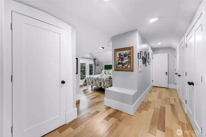 Upper level suite showing extensive wall of storage including the placement of high end washer & dryer.
