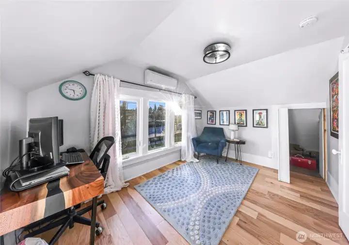 Third bedroom/office with book case shelving open to show closet entry