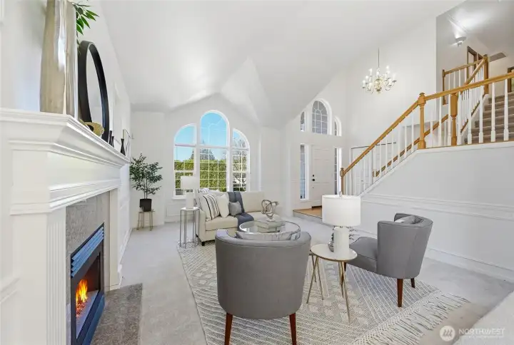 Light-filled, open entry with staircase design amplifies the living room’s spacious feel