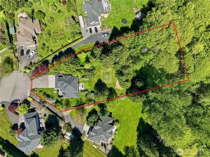 Bird’s-eye view emphasizing the generous lot, outdoor space, and overall property layout. Lot lines are approximate